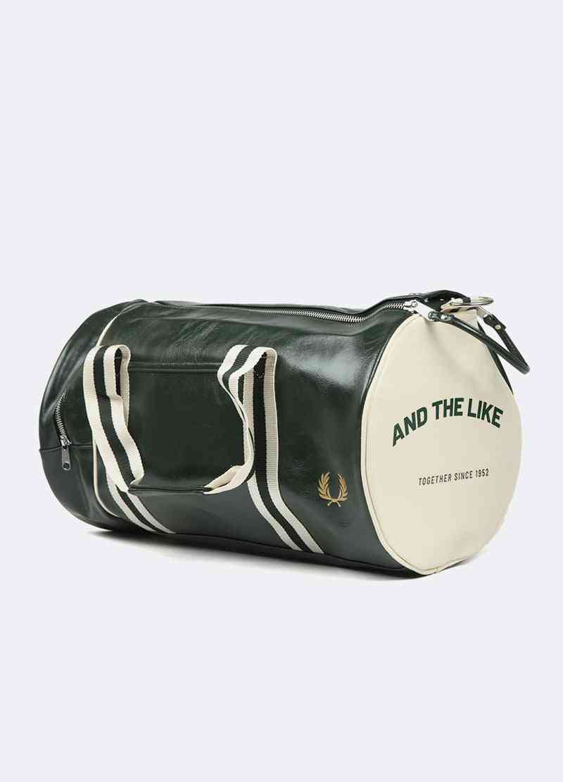 a green and white duffel bag on a white background